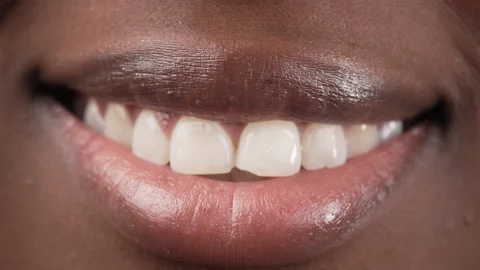 Close up view of a black woman's lips smiling then relaxing. Macro. Stock Footage 209317149