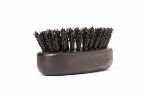 Close up view of a black wood beard brush with natural bristles on a white .. Stock Photos