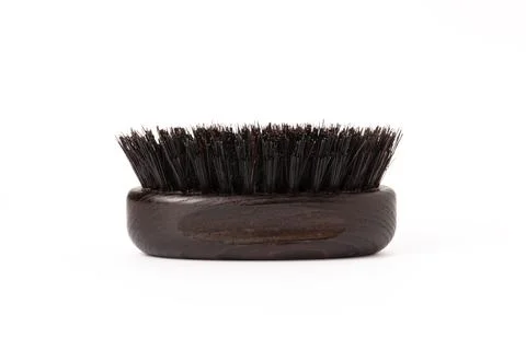 Close up view of a black wood beard brush with natural bristles on a white .. Stock Photos