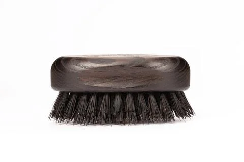 Close up view of a black wood beard brush with natural bristles on a white .. Stock Photos