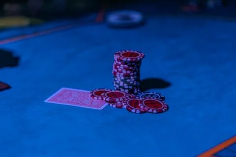 Close-up view of a blackjack game in a dimly lit casino, featuring dark blue  Stock Photos
