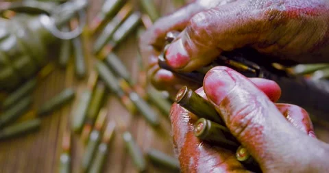 Close-up view of a blood-stained hands of a wounded soldier or insurgent load an Video stock 171196704