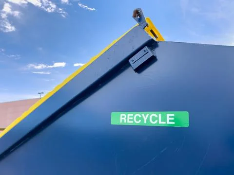 Close Up View Of Blue Dumpster Recycle Sign Stock Photos