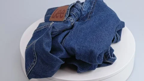 Close-up view of blue LEE jeans on rotating disc. Stock Footage 252395435