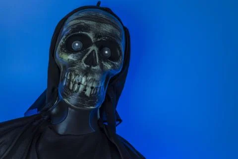 Close up view of blue lighted skeleton head on black background. Stock Photos