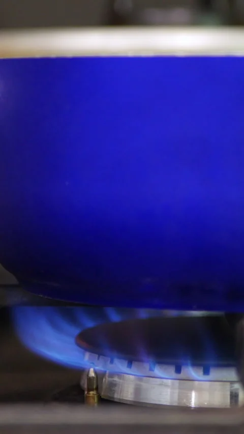 Close-Up View Of A Blue Pot Sitting On A Gas Stove With A Visible Blue Flame Ben Stock-Footage 302540526