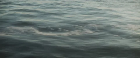 Close up view of blue waves in slow motion, with sun shining above them Stock Footage 147566441