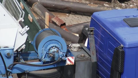 Close-up view of blue winch mechanism with wire rope on heavy construction truck Stock Footage 344864072