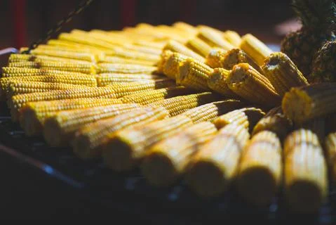 Close up view of boiled corn laid out on counter at Christmas market Stock Photos