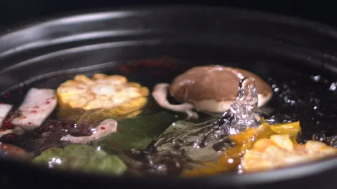 Close-up view of boiling Asian hot pot with mushrooms and vegetables Stock Footage 157842894