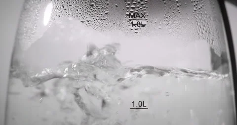 Close up view of boiling water boiling water in a transparent dish or in a glass Stock Footage 237722395