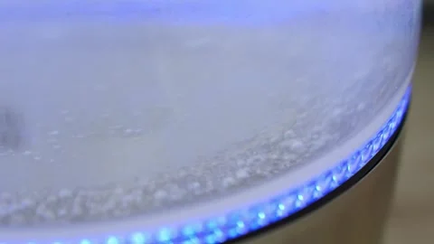 Close up view at boiling water in a kettle, effervescent bubbles, hot drink Stock Footage 300527705