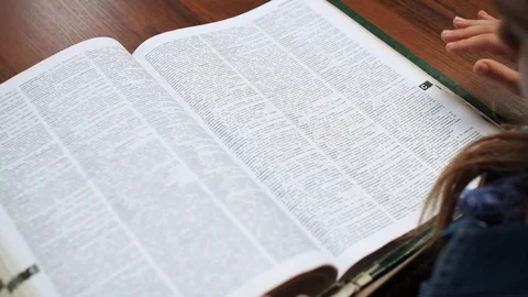 Close-up view of book. Education concept. Schoolgirl touching pages of Video stock 99705423