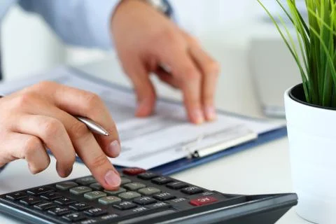 Close up view of bookkeeper hands calculating balance Stock Photos