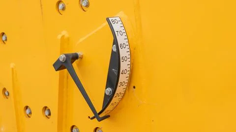 Close up view of boom angle indicator scale on yellow construction machinery Photos