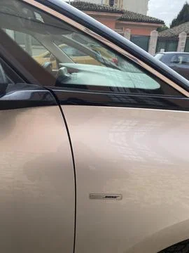 Close up view of the Bose logo on the front door of a beige Renault Espace Stock Photos