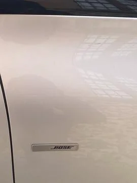 Close up view of the Bose logo on the front door of a beige Renault Espace Stock Photos