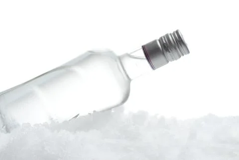 Close-up view of bottle of vodka lying on ice on white Stock Photos