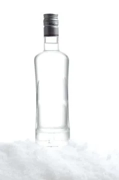 Close-up view of bottle of vodka standing on ice on white Stock Photos