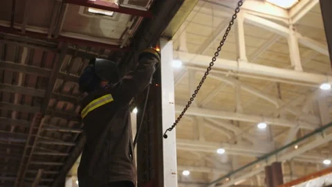 Close-up view from the bottom to factory laborer in protective suit and safety Stock Footage 202049073