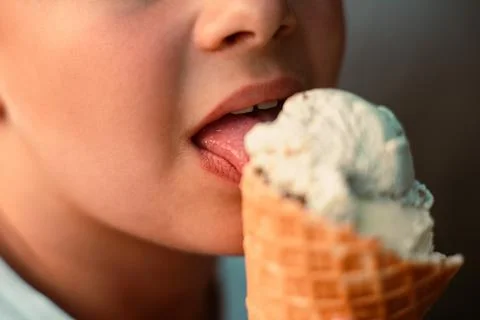Close-up view of a boy eating ice cream in a waffle cup. Macro. Detailed view of Stock Photos