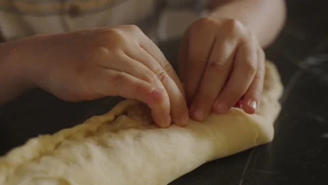 Close-up view of boy's hands making dough and baking cherry pie in the kitchen Stock Footage 241888623