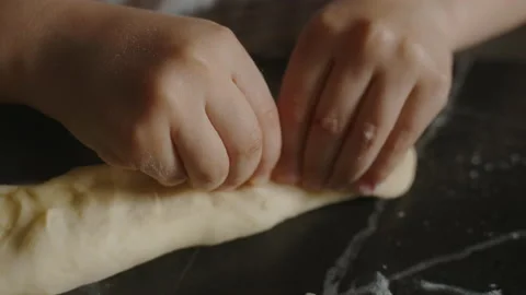 Close-up view of boy's hands sticking dough after putting cherry jam filling to Video stock 237587316