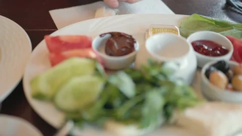 Close up view of breakfast plate with variety of products. Slow motion Stock Footage 189353221