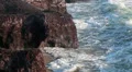 Close up view of breaking rocks waves and Faros beach with liighthouse, Cyprus HD Footage