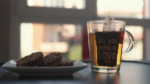 Close up view of brewing tea with a tea bag in glass cup. Stock Footage 204071707