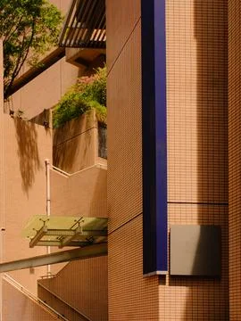 A close-up view of a brick building with a blue accent Stock Photos