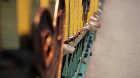 Close up view of a bridge banister with attached lockers on it. Forever in love Stock Footage 99602753