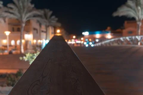 A close up view from a bridge to a blurred basar and palms Stock Photos