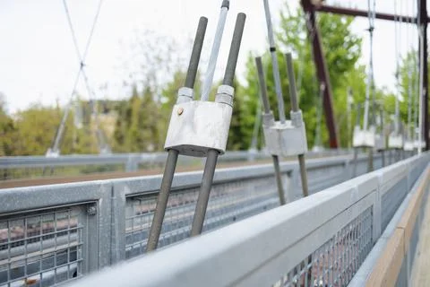 Close view of a bridge structure showing cables and hardware on a cloudy da.. 写真素材