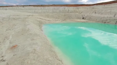 Close view of bright azure water pool in white kaolin clay pit outdoors Stock Footage 344812240