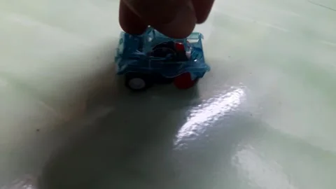 A close up view of a bright blue children's toy car taken from a high angle Video stock 294395155