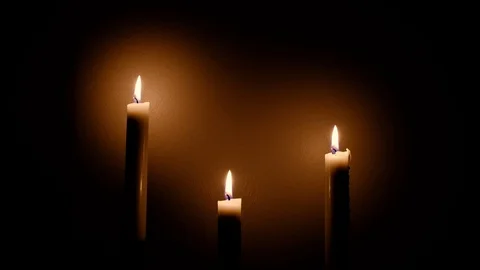 Close-up view of bright burning candles in a dark room. Warming cozy atmosphe Stock Footage 124699471