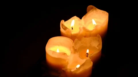 Close-up view of bright burning candles in a dark room. Warming cozy atmosphe Stock Footage 124699499