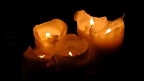 Close-up view of bright burning candles in a dark room. Warming cozy atmosphe Stock Footage 124699554