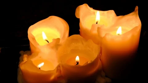 Close-up view of bright burning candles in a dark room. Warming cozy atmosphe Stock Footage 125009582
