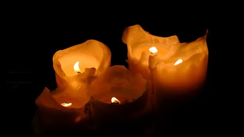 Close-up view of bright burning candles in a dark room. Warming cozy atmosphe Stock Footage 127510174