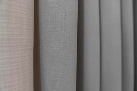 Close-up view of bright curtain in thin and thick vertical folds made of dense Stock Photos