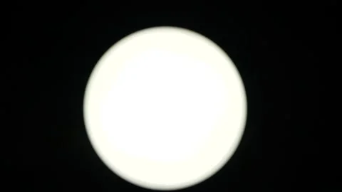 Close-up view of a bright white circle, similar to the moon, which the wind Stock Footage 138221564