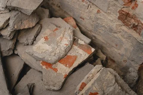 Close-up view of broken bricks, concrete and masonry debris from a damaged or Stock Photos