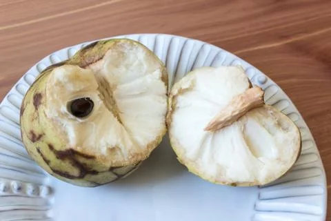Close view of a broken open cherimoya fruit Annona cherimola Stock Photos