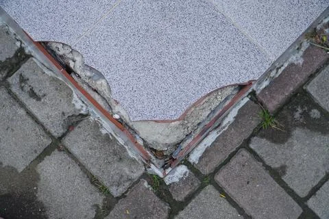 Close up view of broken tile. Cracked asbestos floor tile. Damaged ceramic .. Stock Photos