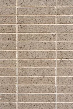 Close up view of brown brick wall with dark spots. Sleek material arranged in Foto stock