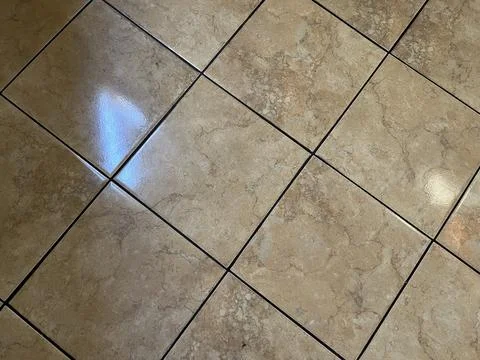 Close up view of brown checkered tile flooring with wood pattern Stock Photos