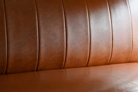 Close up view of a brown leather bench showcasing its rich texture, smooth .. Foto stock