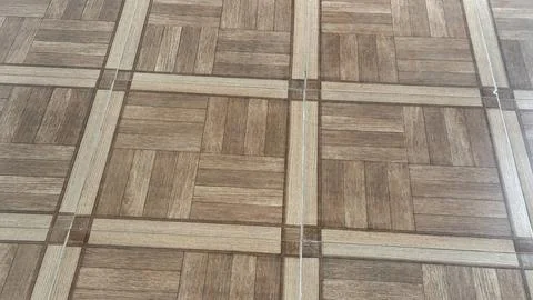 A close-up view of a brown patterned tiled floor, showcasing a classic and ve Foto stock